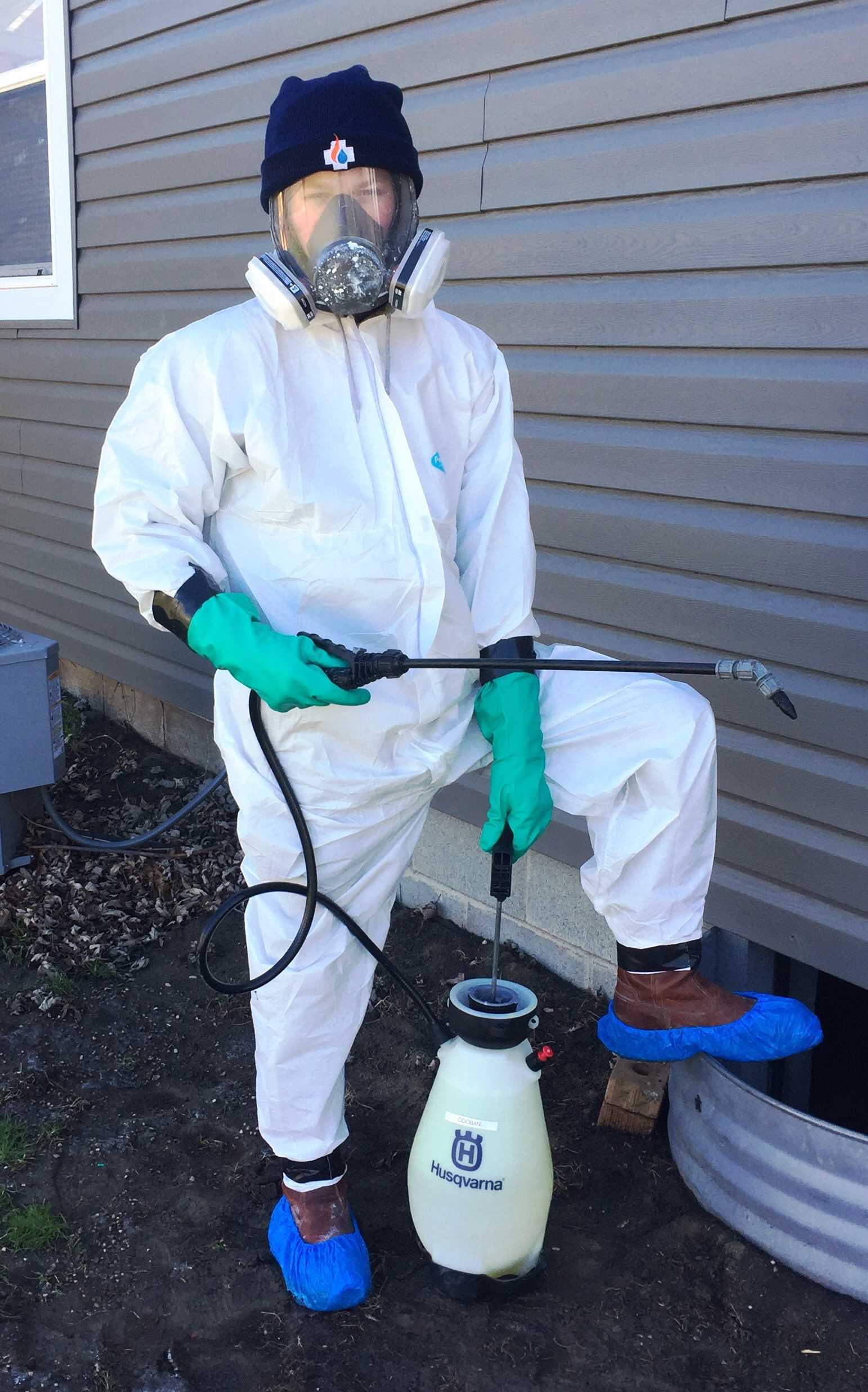 Person dressed with protection to clean mold